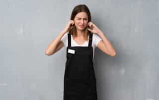 employee woman frustrated and covering ears with hands